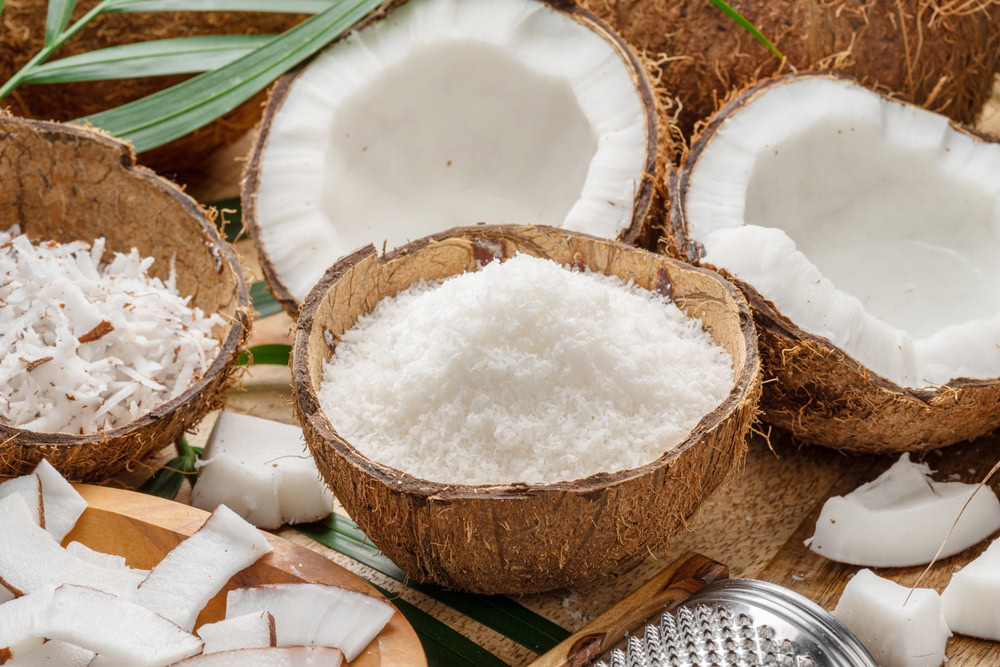 Fresh opened coconuts along with coconut slices