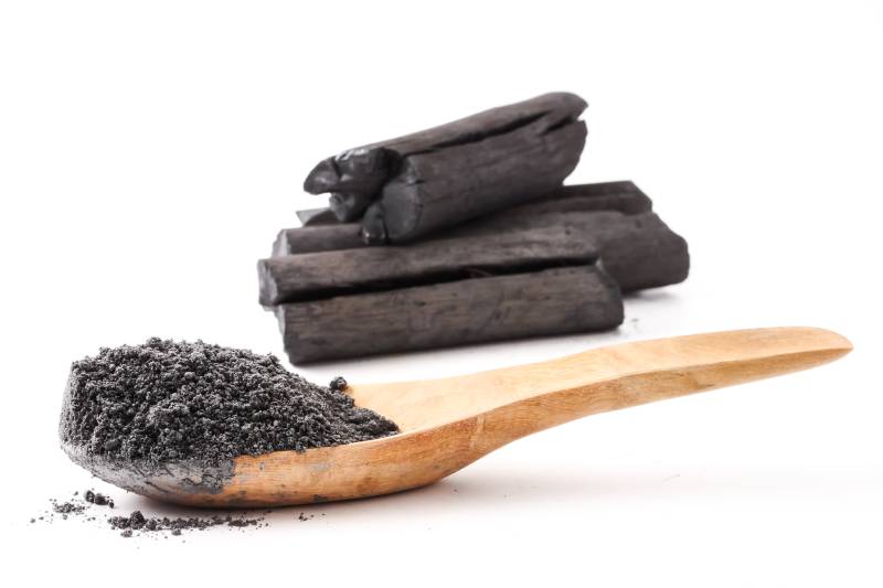 Activated charcoal powder on white background