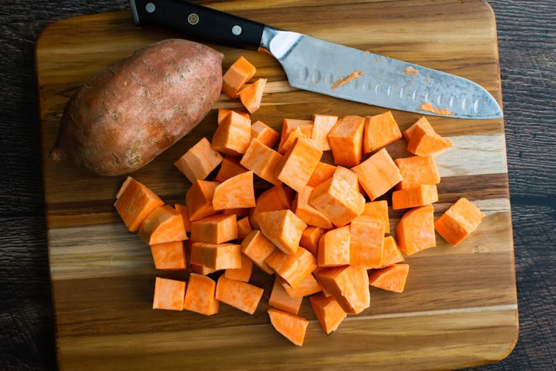 Diced sweet potato on chopping board