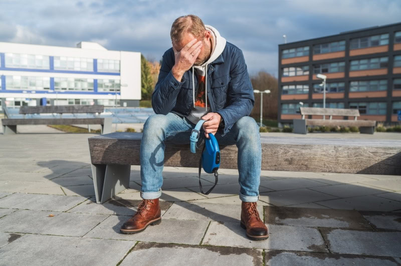 Man crying over the loss of his pet dog