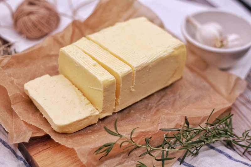 a block of butter being sliced