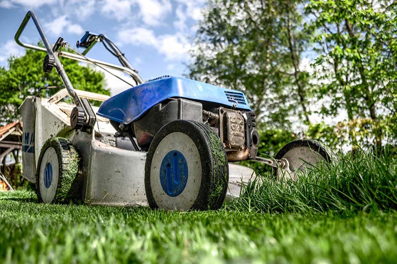 a lawn mower in the frontyard