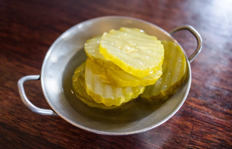 a small bowl of pickle slices
