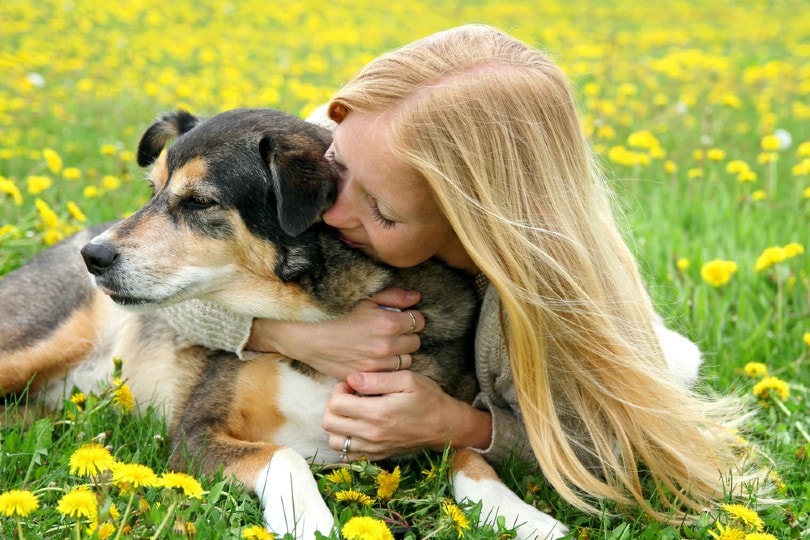 woman hugging dog
