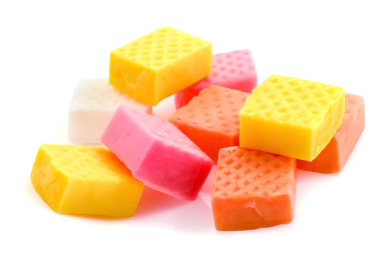 chewing fruit caramel candies close-up isolated on white background