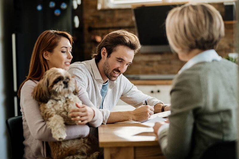couple with a dog getting a pet insurance
