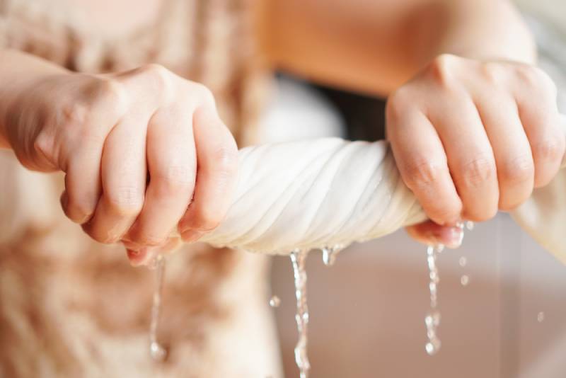 hand squeezing wet cloth
