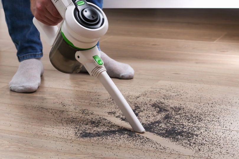 man using cordless vacuum