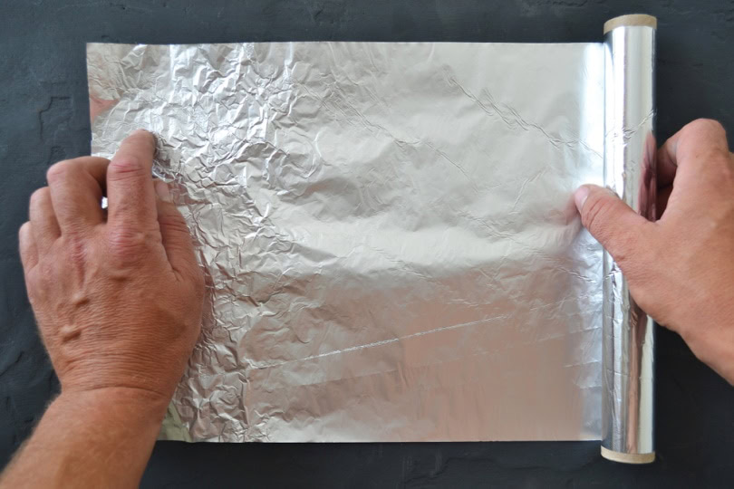 mans hand holding foil