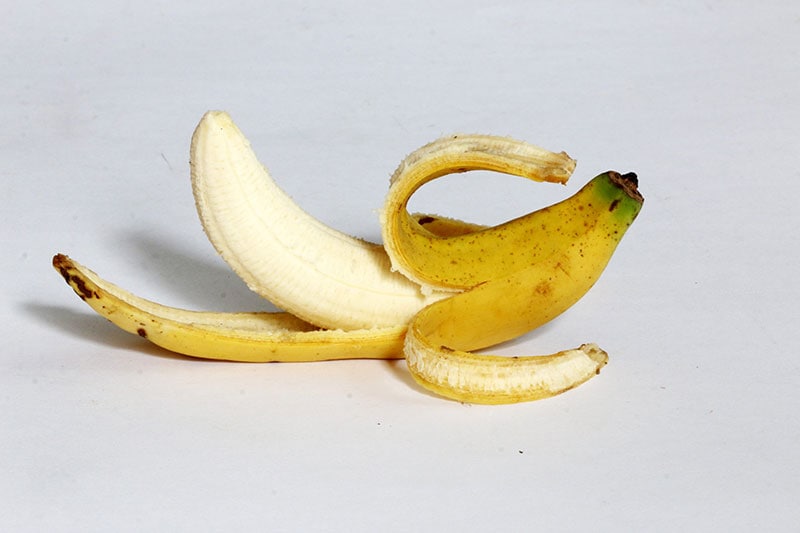 peeled banana on white background