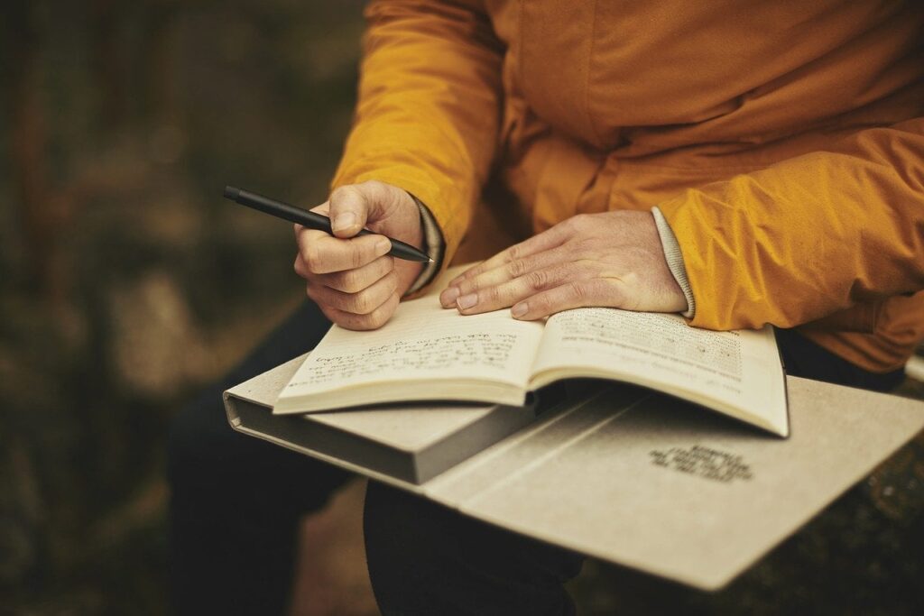 person writing a journal