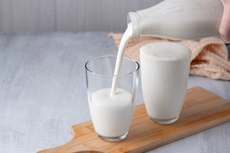 pouring milk in a glass