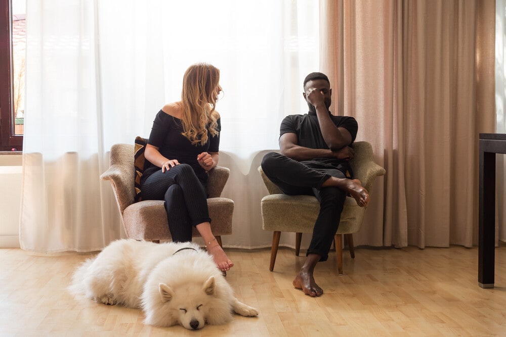 Man and woman arguing with dog