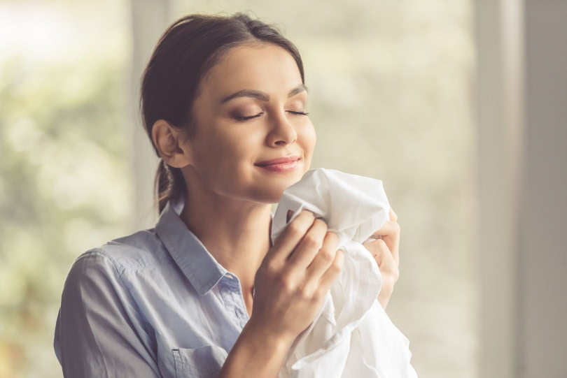 woman smelling clothes