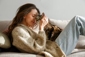 young woman holding cute siberian cat