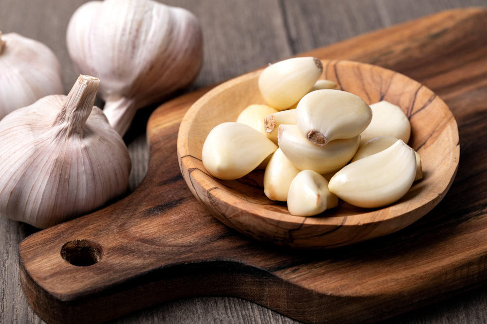 Garlic Cloves and Bulb in vintage wooden