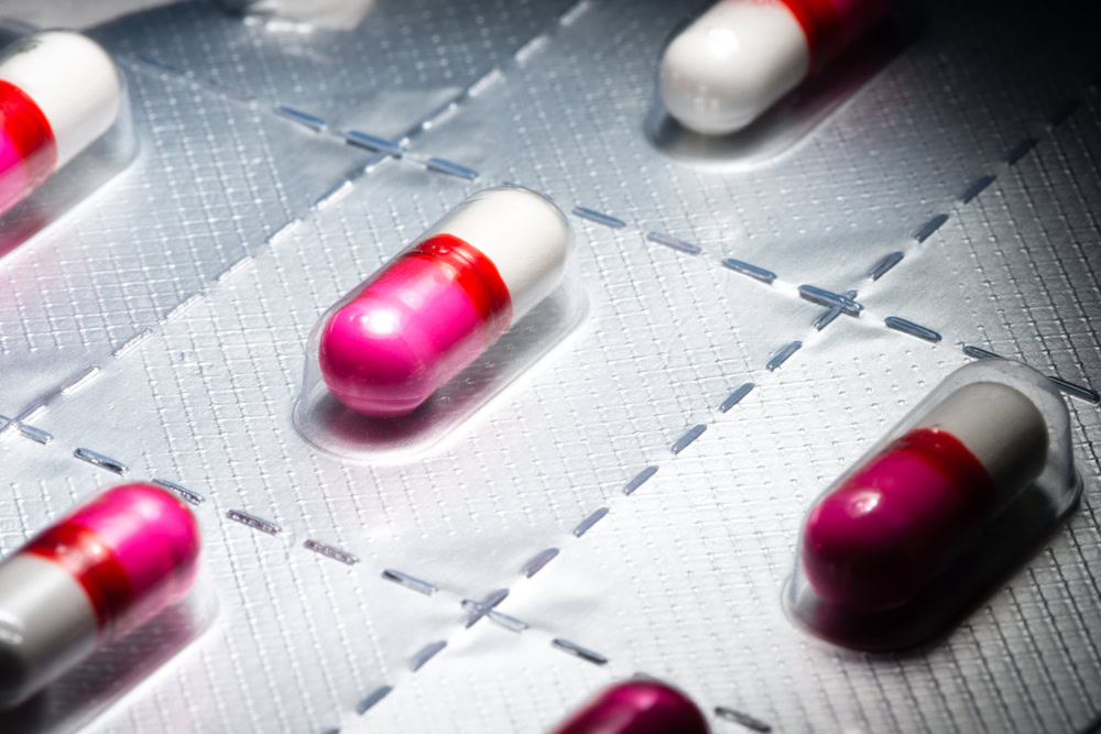 Pink antihistamine capsules in blister pack
